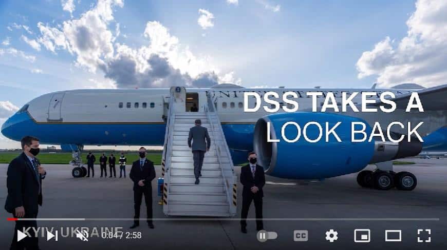 Screenshot of "DSS Takes Look Back at 2021" video showing Special Agents protecting Secretary Blinken as he boards an airplane in Kyiv, Ukraine.